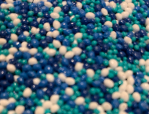 Close-up of blue, teal and white PolySoft beads in an aquatic colour blend