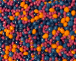 Close-up of navy, pink and orange PolySoft beads in a vivid playground colour blend